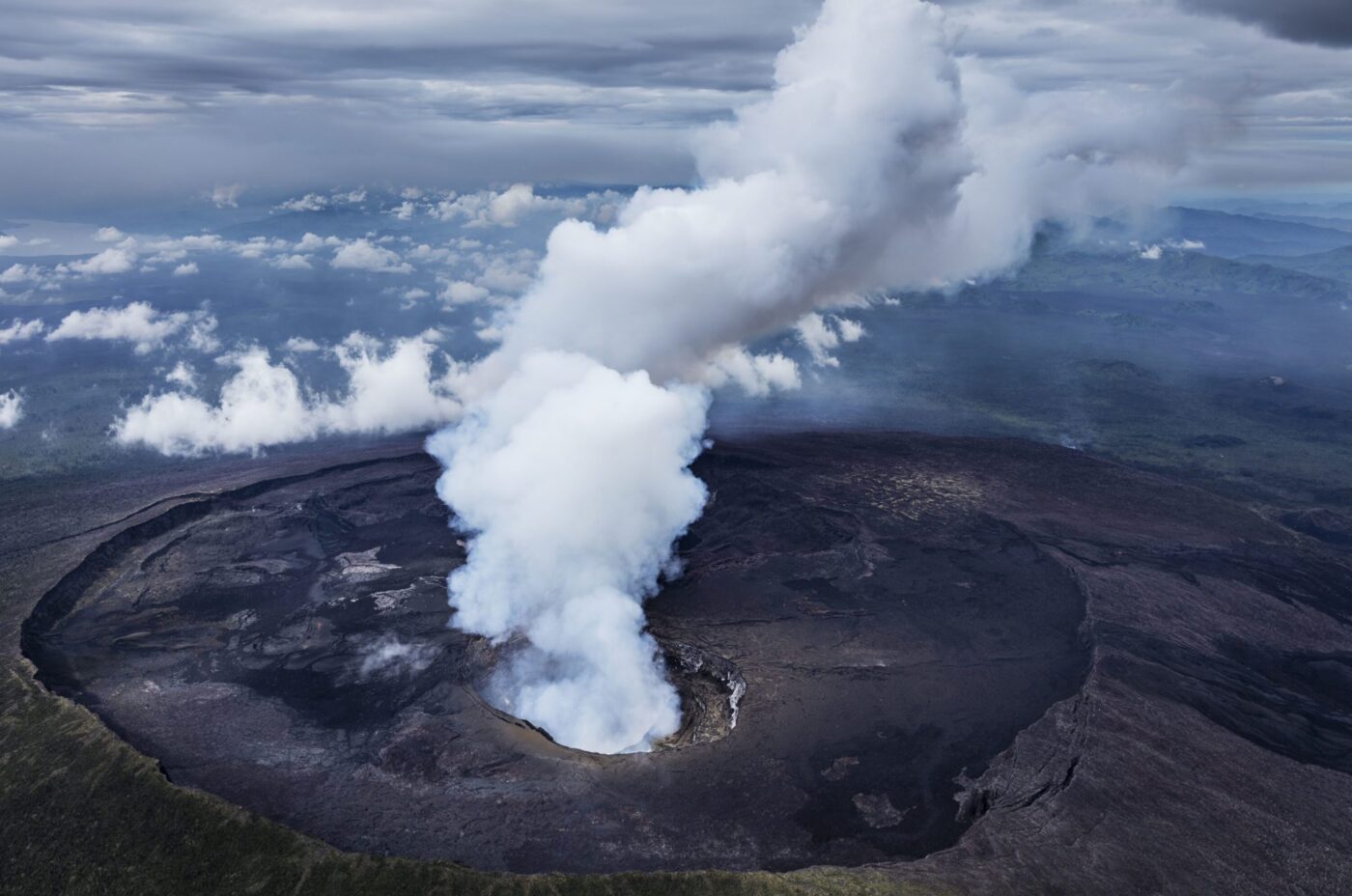 an aerial view of Nyiragongo crater's steam rising