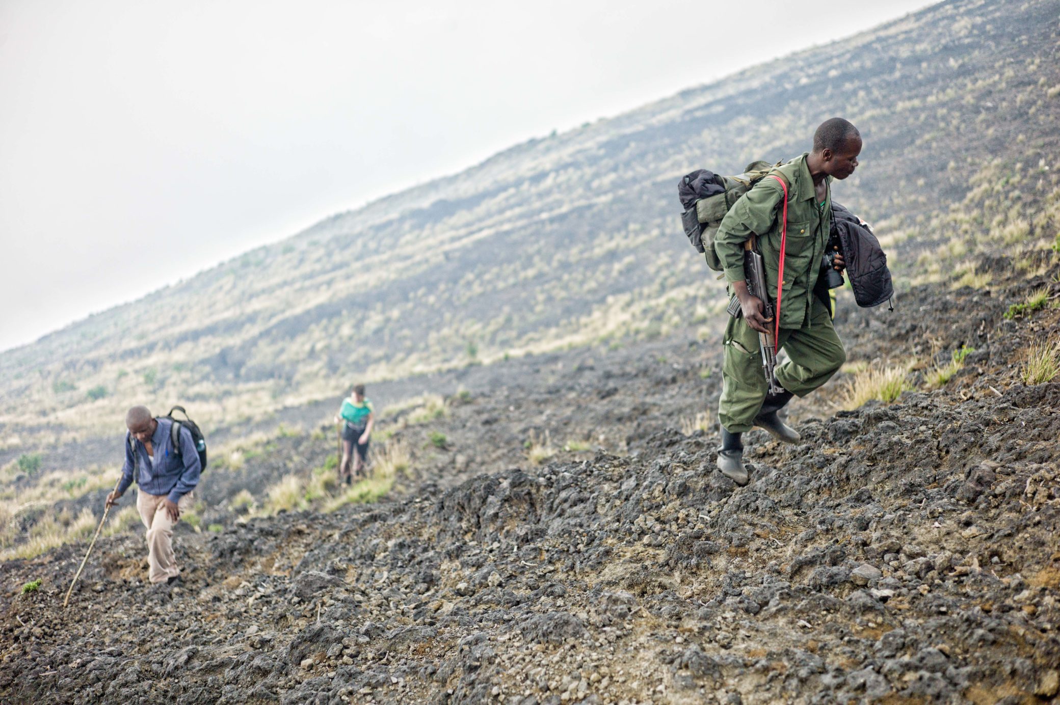 ranger and trekkers climbing to summit of Nyiragongo